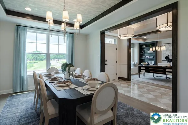 a dining room with furniture a chandelier and window