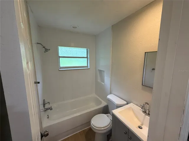 a bathroom with a toilet a sink and bathtub