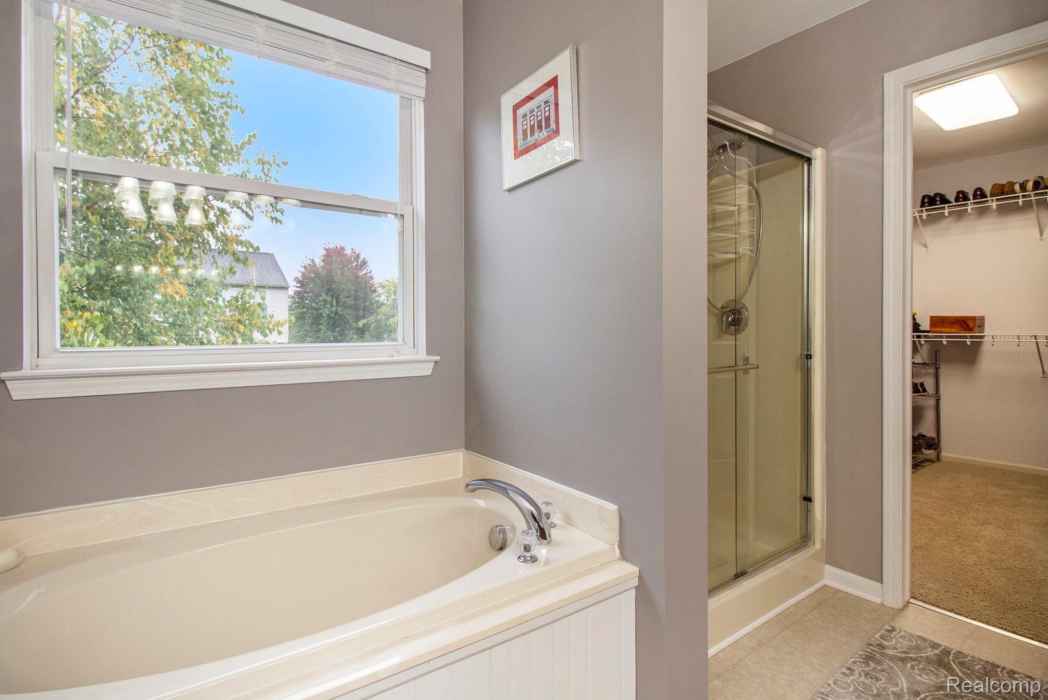1024 Walcott Lane Howell, MI 48843 - Photo 22 of 30 Master bathroom soaking tub & shower, lg walk-in closet.jpg