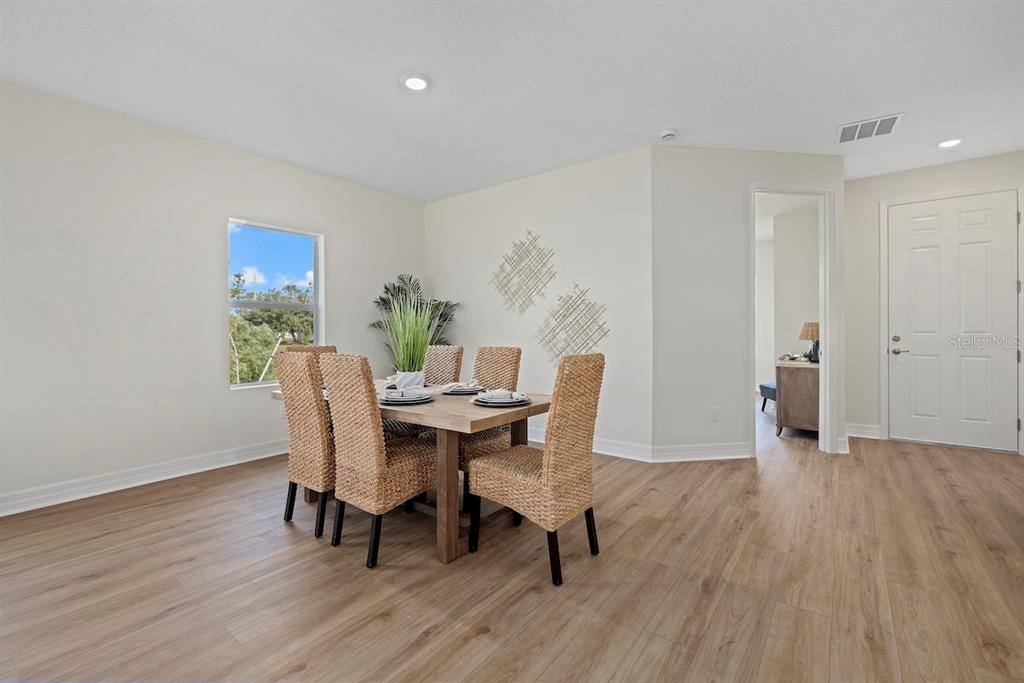 3883 Dominic Street North Port, FL 34288 - Photo 12 of 24 a view of a dining room with furniture and wooden floor