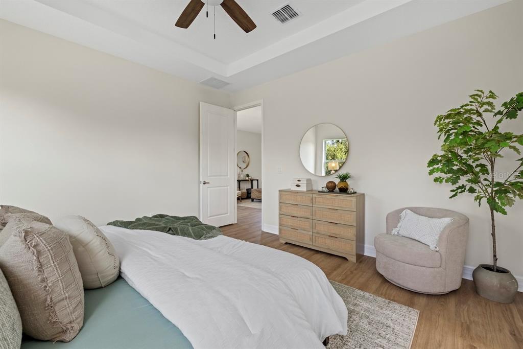 3883 Dominic Street North Port, FL 34288 - Photo 18 of 24 a bedroom with a bed and a chandelier