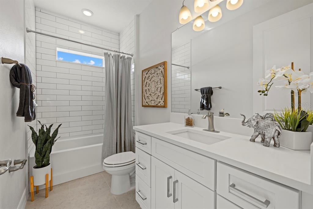 3883 Dominic Street North Port, FL 34288 - Photo 22 of 24 a bathroom with a toilet a sink and mirror