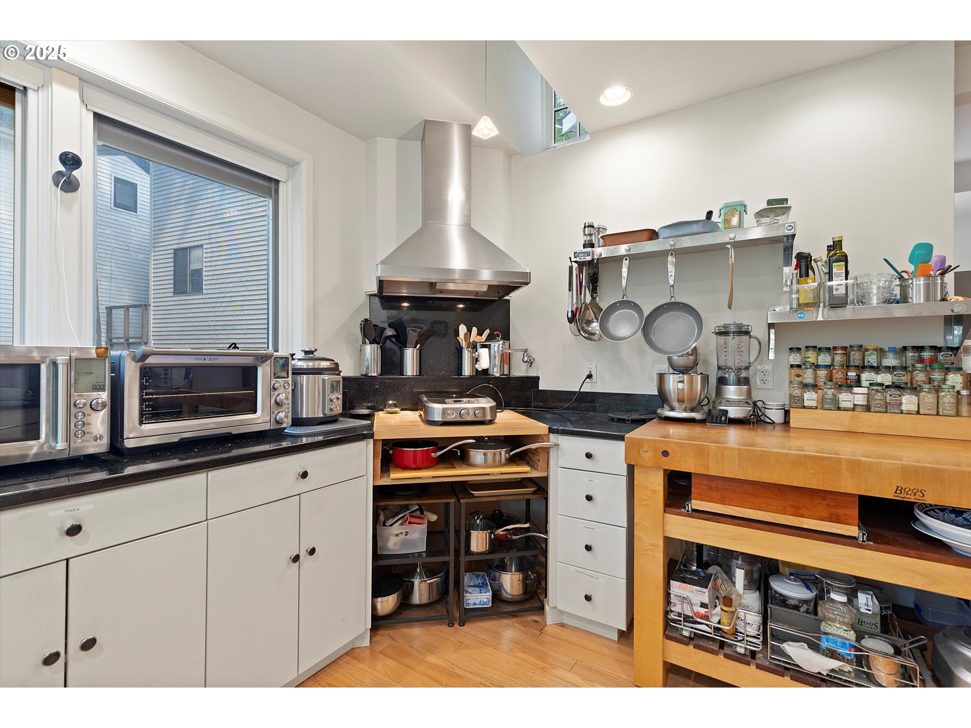 1757 Southwest Prospect Drive Portland, OR 97201 - Photo 20 of 48 a kitchen with stainless steel appliances granite countertop a stove a sink and a microwave