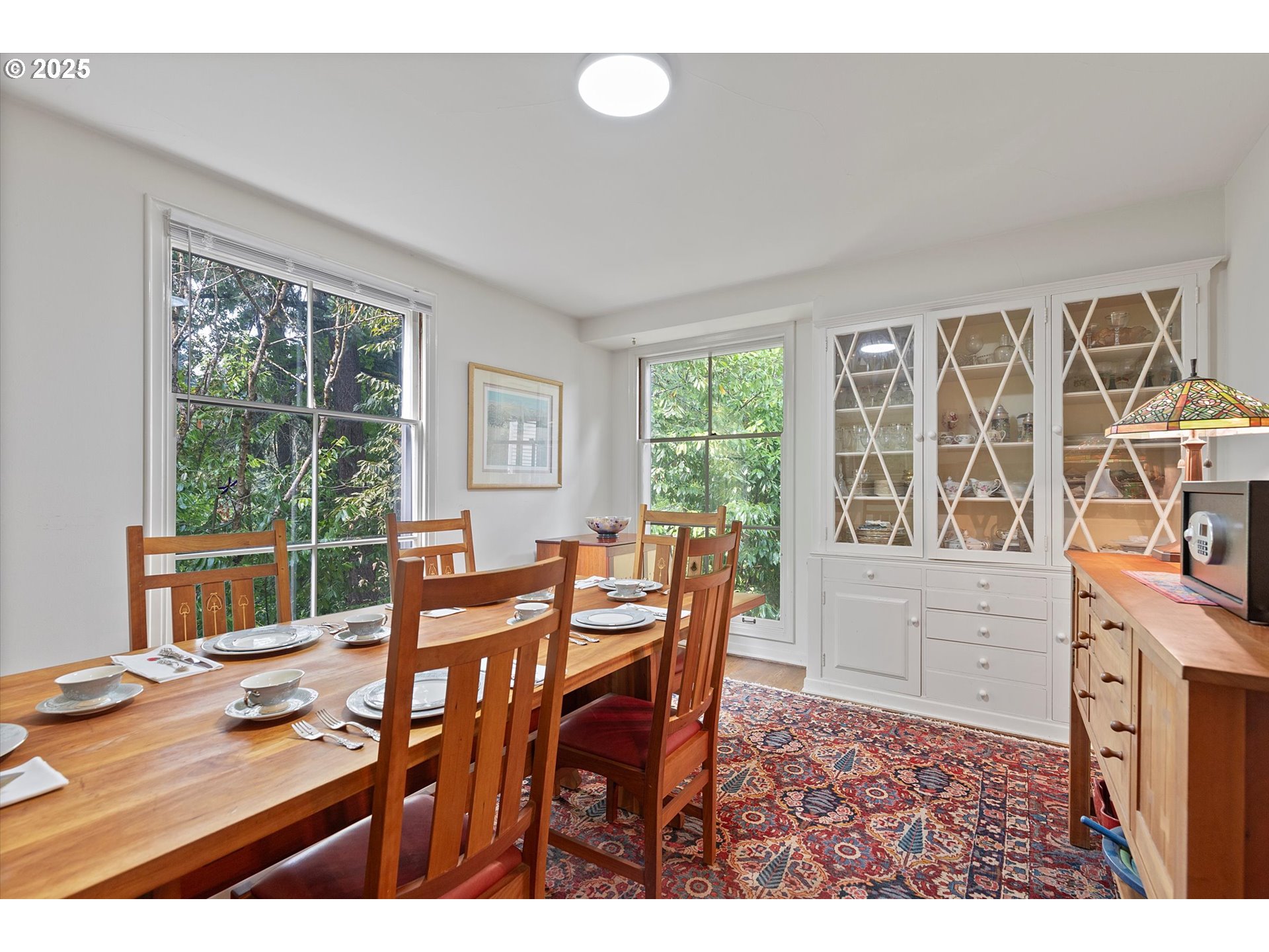 1757 Southwest Prospect Drive Portland, OR 97201 - Photo 23 of 48 a view of a dining room with furniture large windows and wooden floor