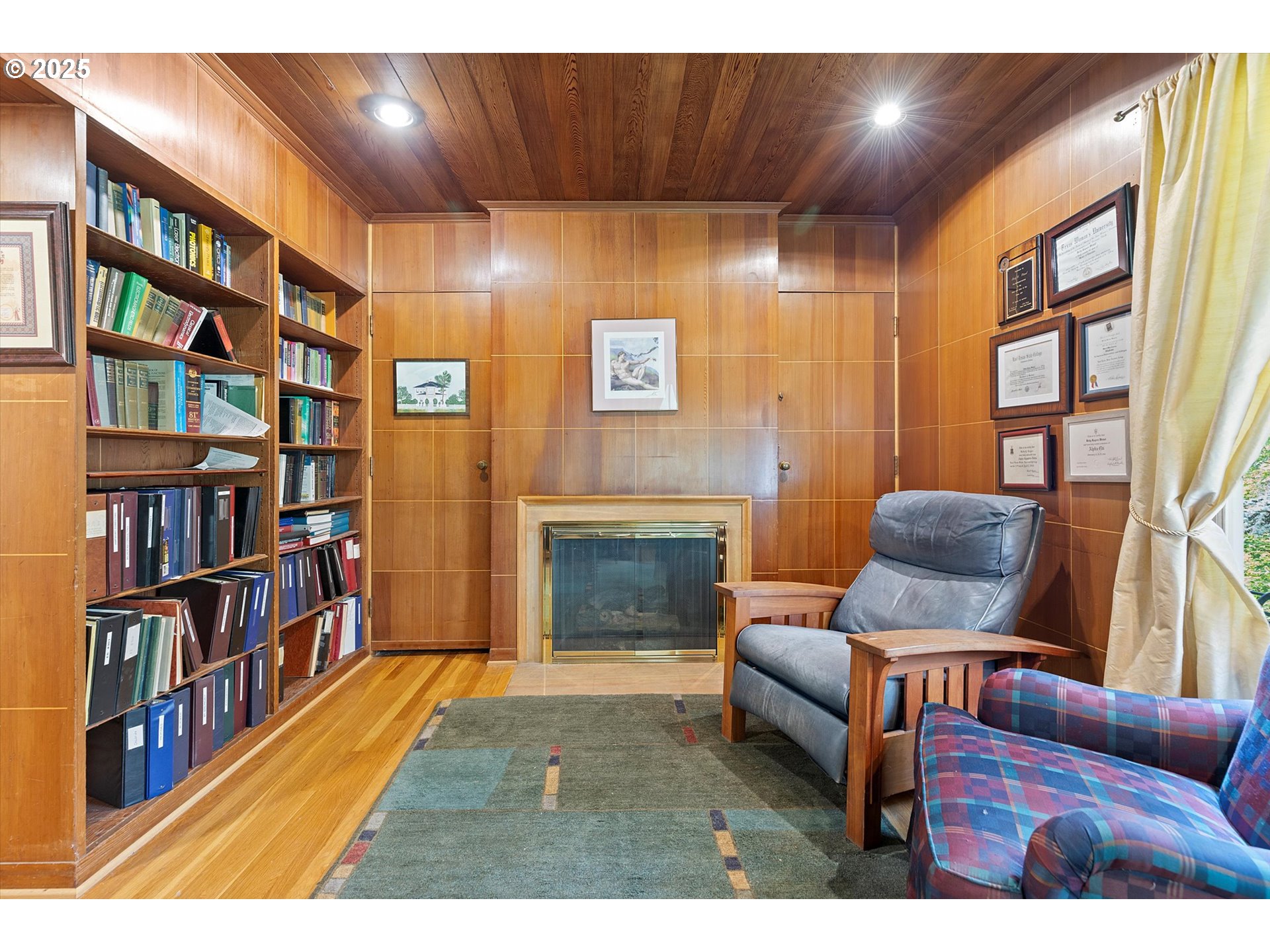 1757 Southwest Prospect Drive Portland, OR 97201 - Photo 6 of 48 a living room with furniture a bookshelf and a fireplace