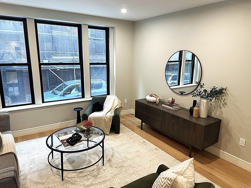 14 North Bennet Street, Unit 1 Boston, MA 02113 - Photo 1 of 20 a living room with furniture and a large window