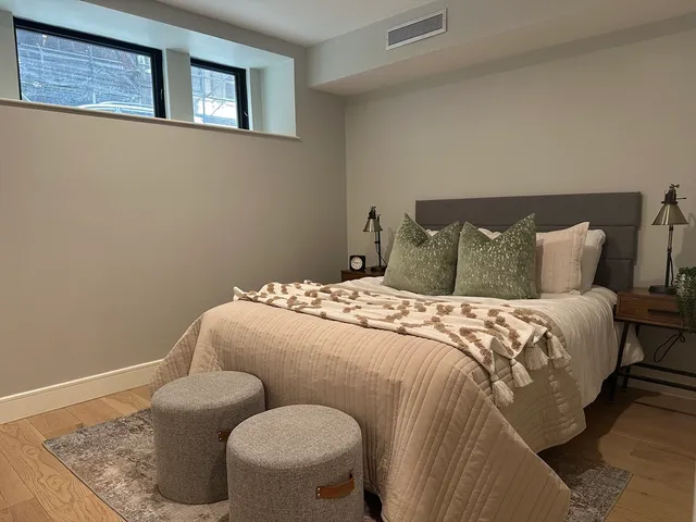a bedroom with a bed and chair