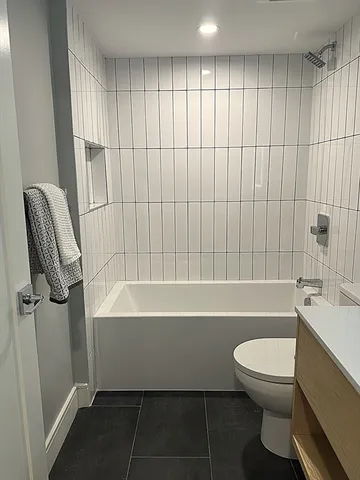 a bathroom with a toilet a sink and bathtub
