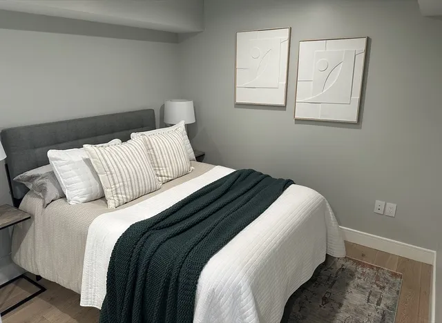 a bedroom with a bed and a window