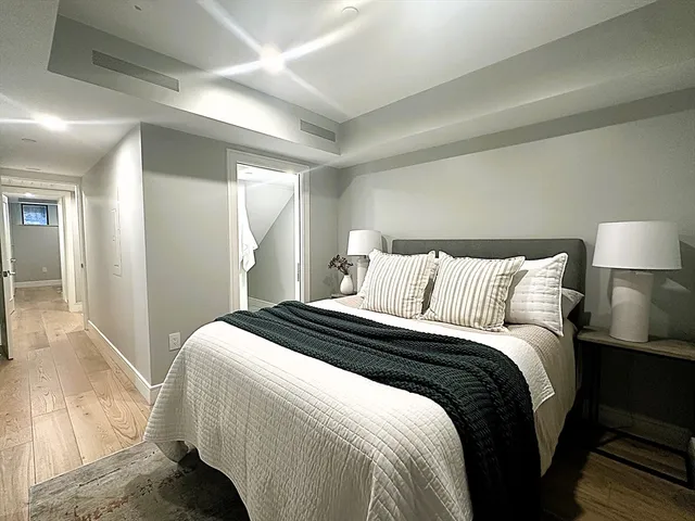 a bedroom with a bed and a lamp