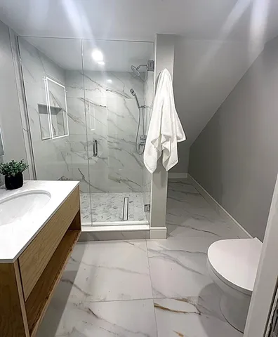 a bathroom with a sink a toilet and a shower