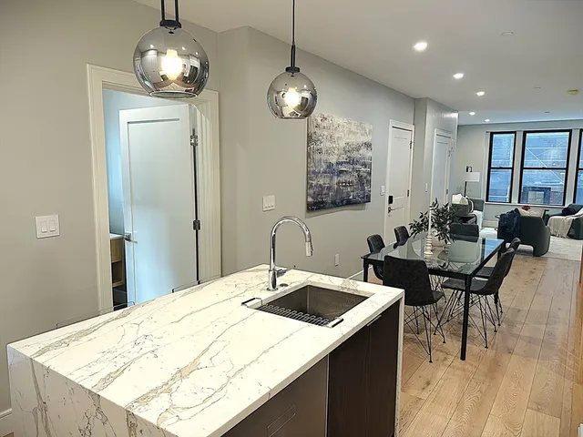 a kitchen with a table chairs and microwave