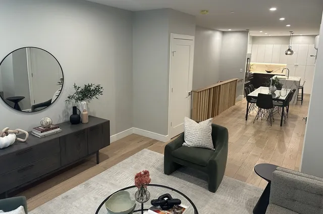 a living room with furniture and a mirror