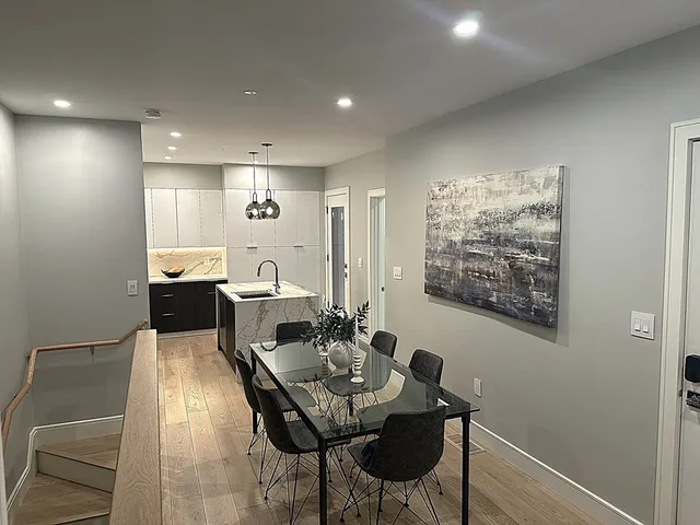 a view of a dining room with furniture and a potted plant