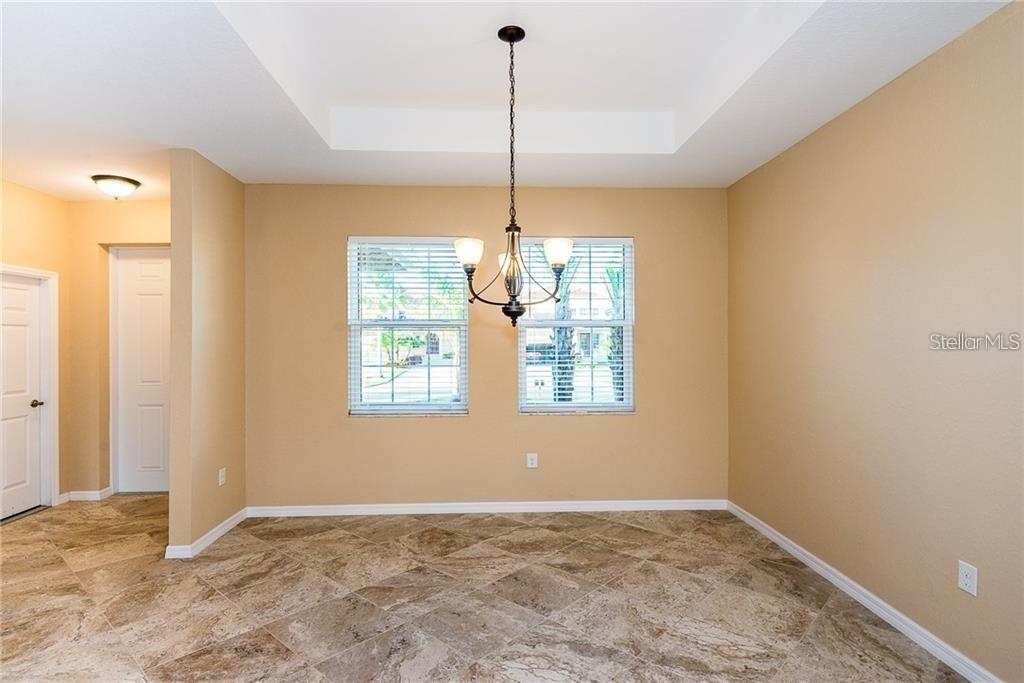 3948 San Rocco Drive, Unit 112 Punta Gorda, FL 33950 - Photo 10 of 18 a view of an empty room and window and chandelier fan