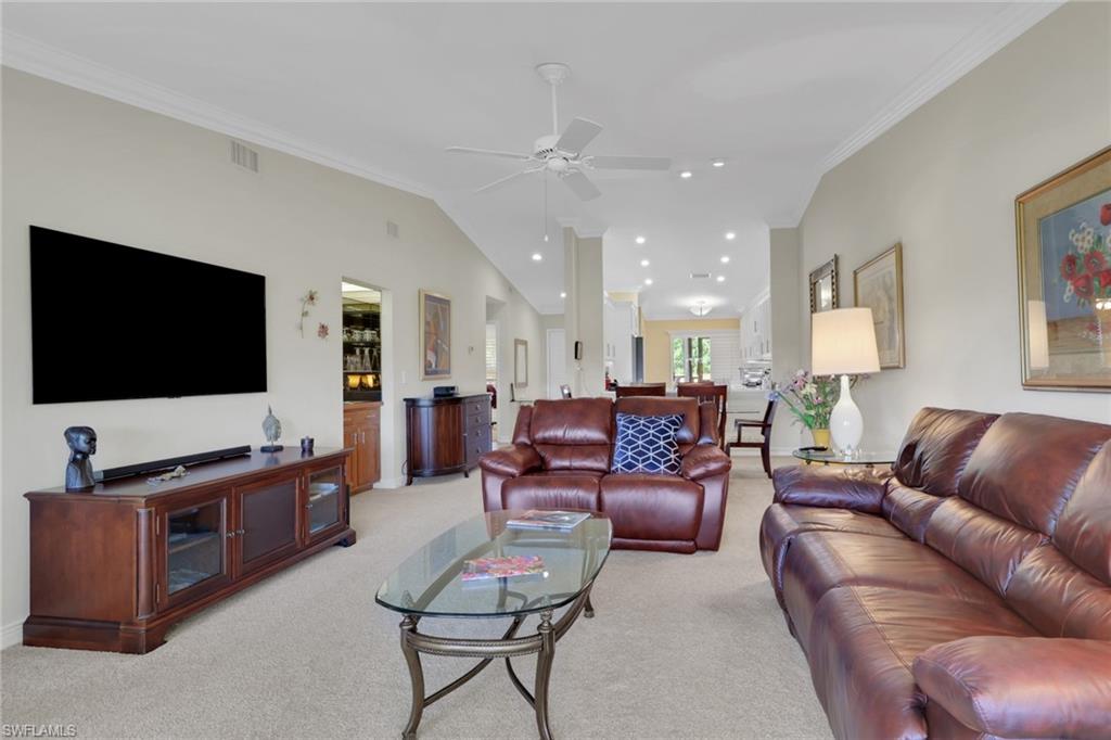 406 Foxtail Court, Unit 406 Naples, FL 34104 - Photo 17 of 42 a living room with furniture and a flat screen tv