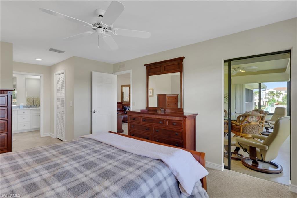 406 Foxtail Court, Unit 406 Naples, FL 34104 - Photo 19 of 42 a bedroom with a bed and a dresser