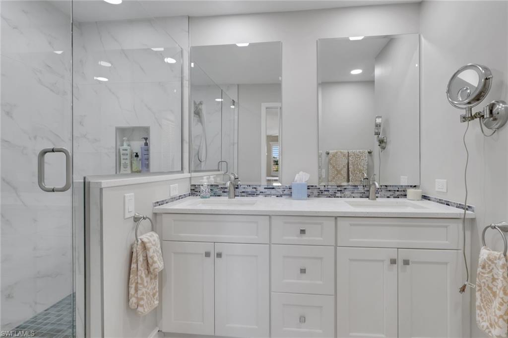 406 Foxtail Court, Unit 406 Naples, FL 34104 - Photo 20 of 42 a bathroom with a granite countertop sink and a mirror