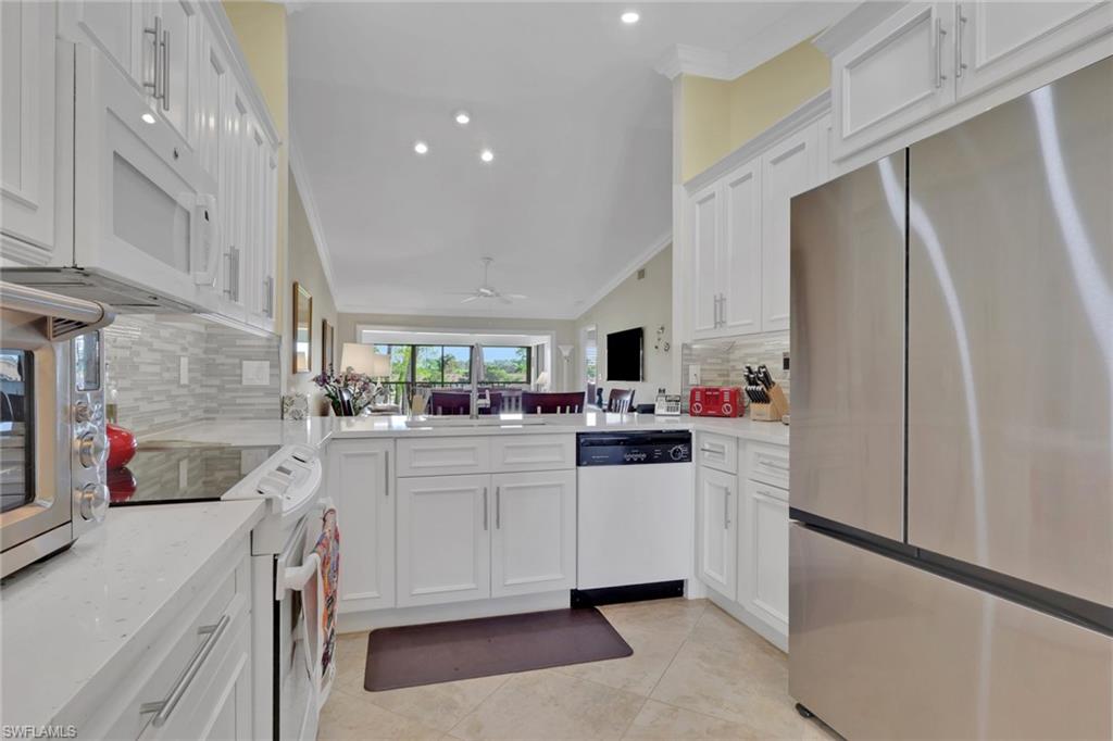 406 Foxtail Court, Unit 406 Naples, FL 34104 - Photo 2 of 42 a kitchen with cabinets a sink and appliances
