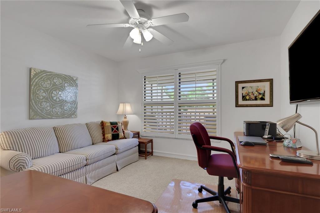 406 Foxtail Court, Unit 406 Naples, FL 34104 - Photo 21 of 42 a living room with furniture a flat screen tv and a window