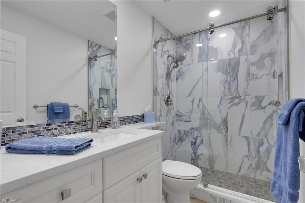 406 Foxtail Court, Unit 406 Naples, FL 34104 - Photo 22 of 42 a bathroom with a sink toilet double vanity and shower