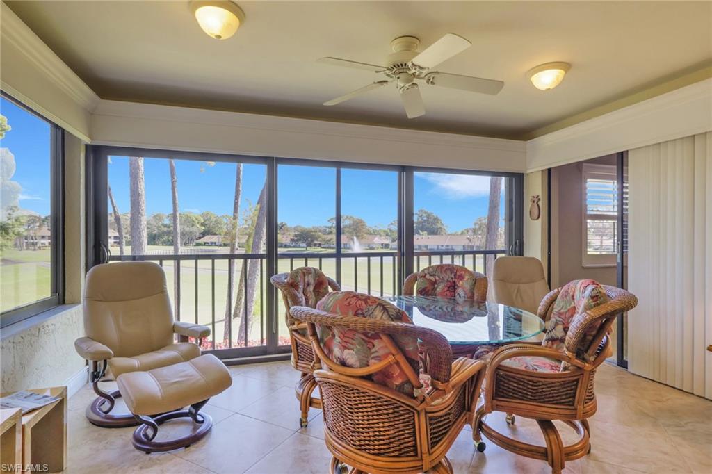 406 Foxtail Court, Unit 406 Naples, FL 34104 - Photo 23 of 42 a living room with furniture and a floor to ceiling window