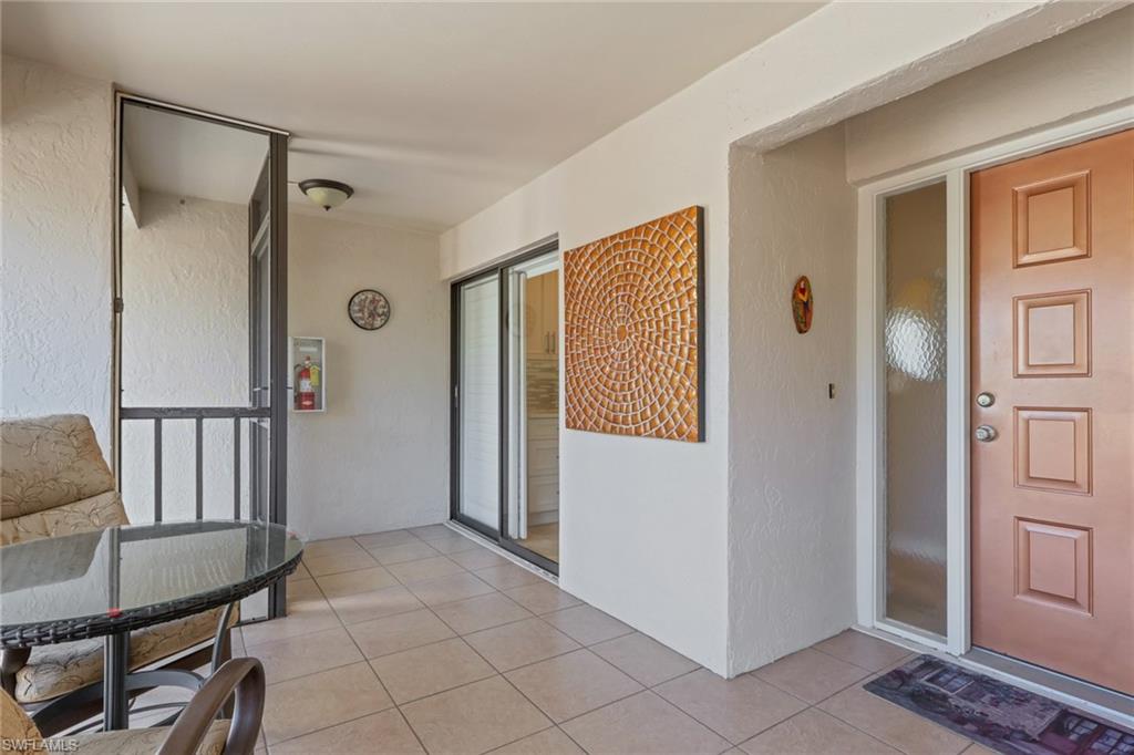 406 Foxtail Court, Unit 406 Naples, FL 34104 - Photo 8 of 42 a view of a livingroom with entryway and dining room