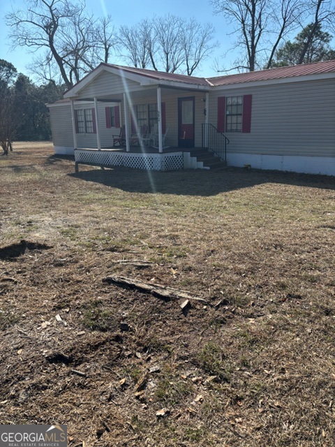 592 Clifford Meeks Road Collins, GA 30421 - Photo 19 of 52 a front view of a house with a yard