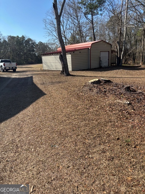 592 Clifford Meeks Road Collins, GA 30421 - Photo 20 of 52 a house with trees in the background