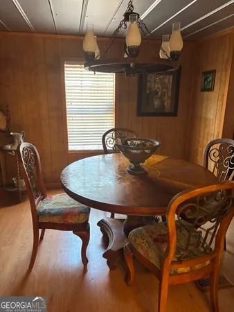 a table and chairs in a room with window