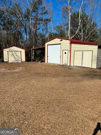 a view of a house with a yard and garage