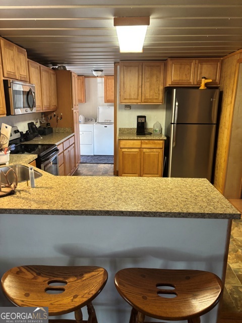 592 Clifford Meeks Road Collins, GA 30421 - Photo 4 of 52 a kitchen with a refrigerator a stove top oven a sink a dining table and chairs