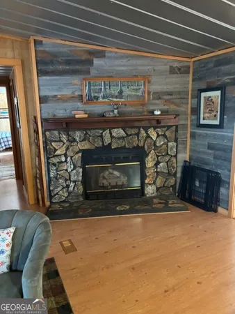 a living room with furniture a fireplace and a window