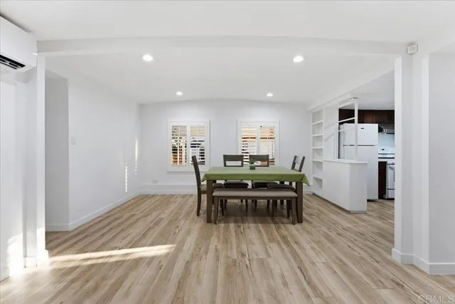 a dining room with furniture and wooden floor
