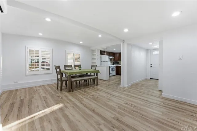 a kitchen with a refrigerator and a table
