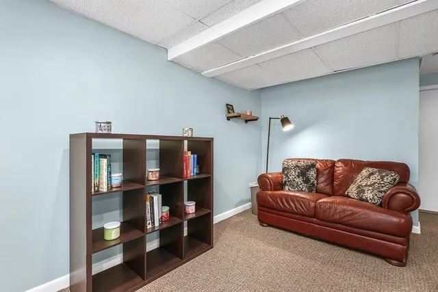 a living room with furniture a shelf and a book shelf