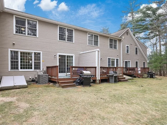 a view of a house with a patio and a yard