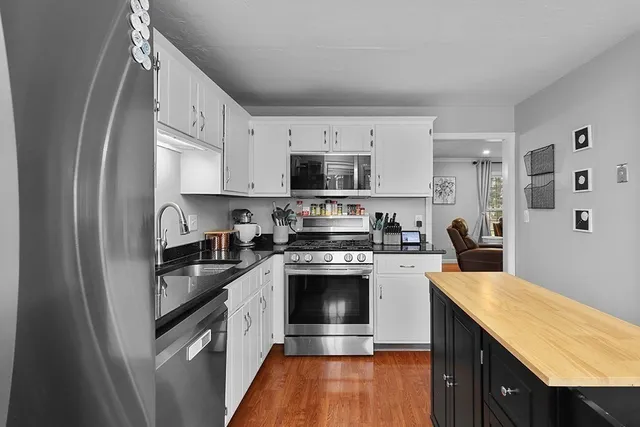 a kitchen with stainless steel appliances granite countertop a stove sink and refrigerator