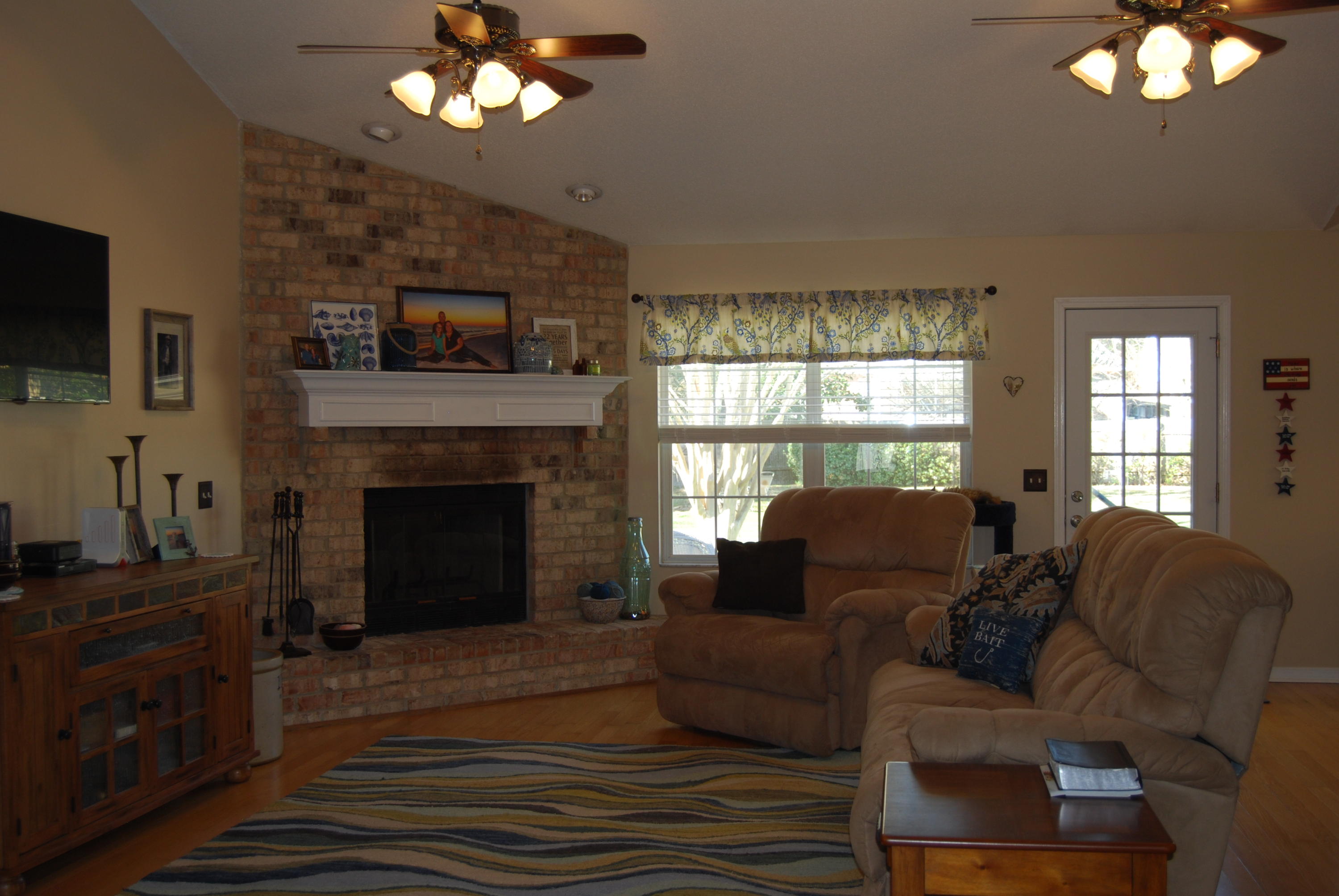 4455 Kingslynn Road Niceville, FL 32578 - Photo 2 of 36 a living room with furniture a fireplace and a flat screen tv