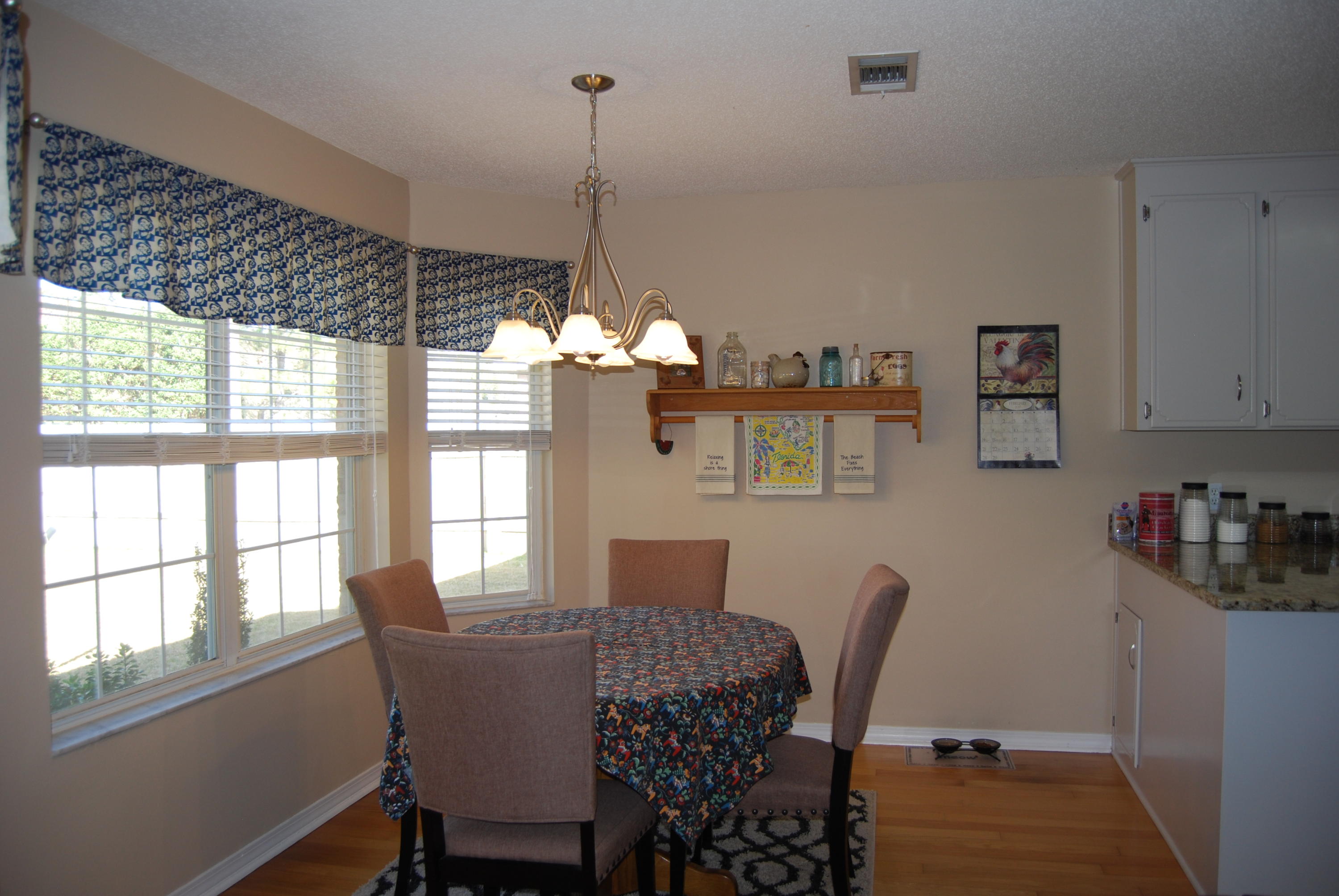 4455 Kingslynn Road Niceville, FL 32578 - Photo 14 of 36 a view of a dining room with furniture window and wooden floor