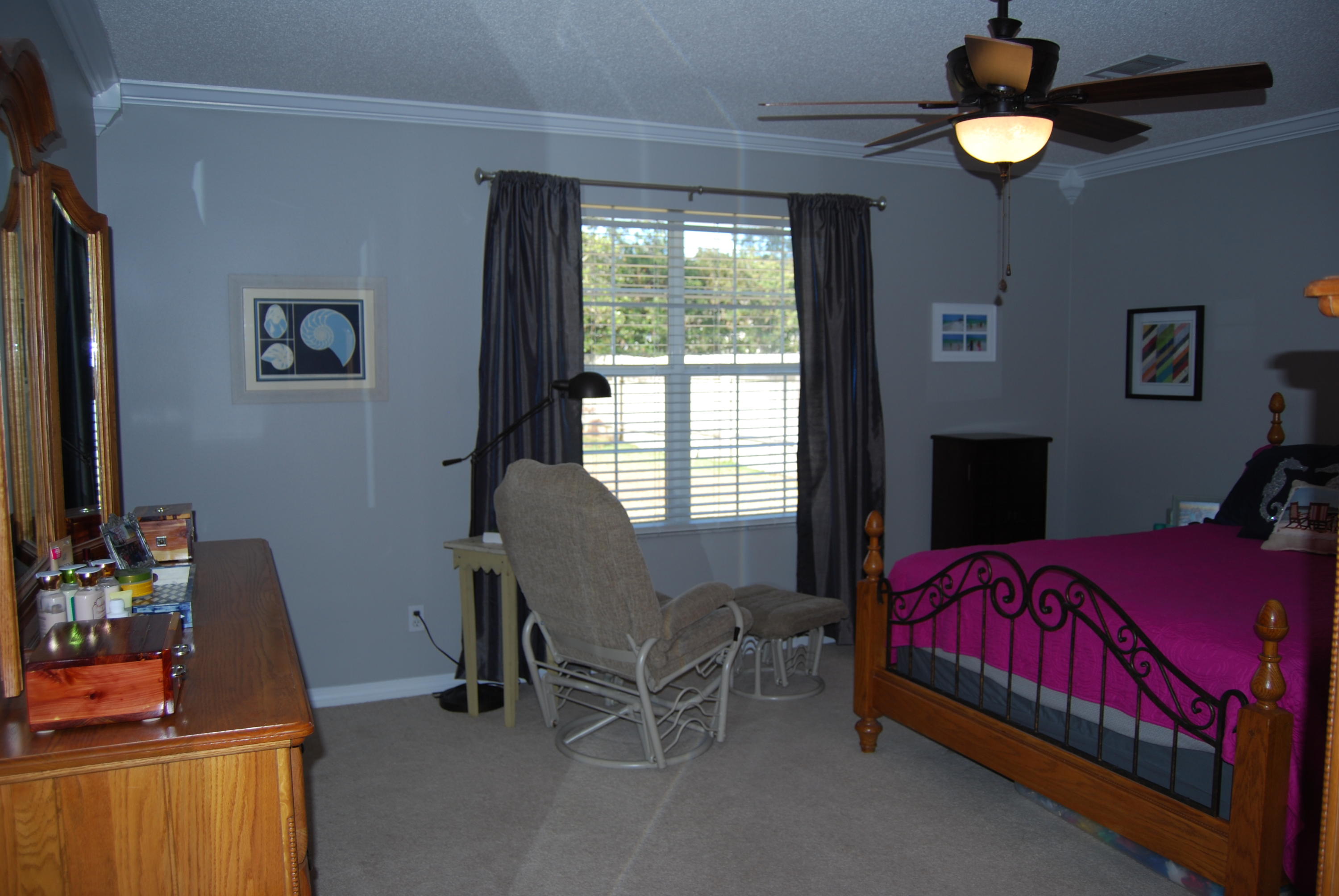 4455 Kingslynn Road Niceville, FL 32578 - Photo 15 of 36 a bedroom with a bed and a chandelier