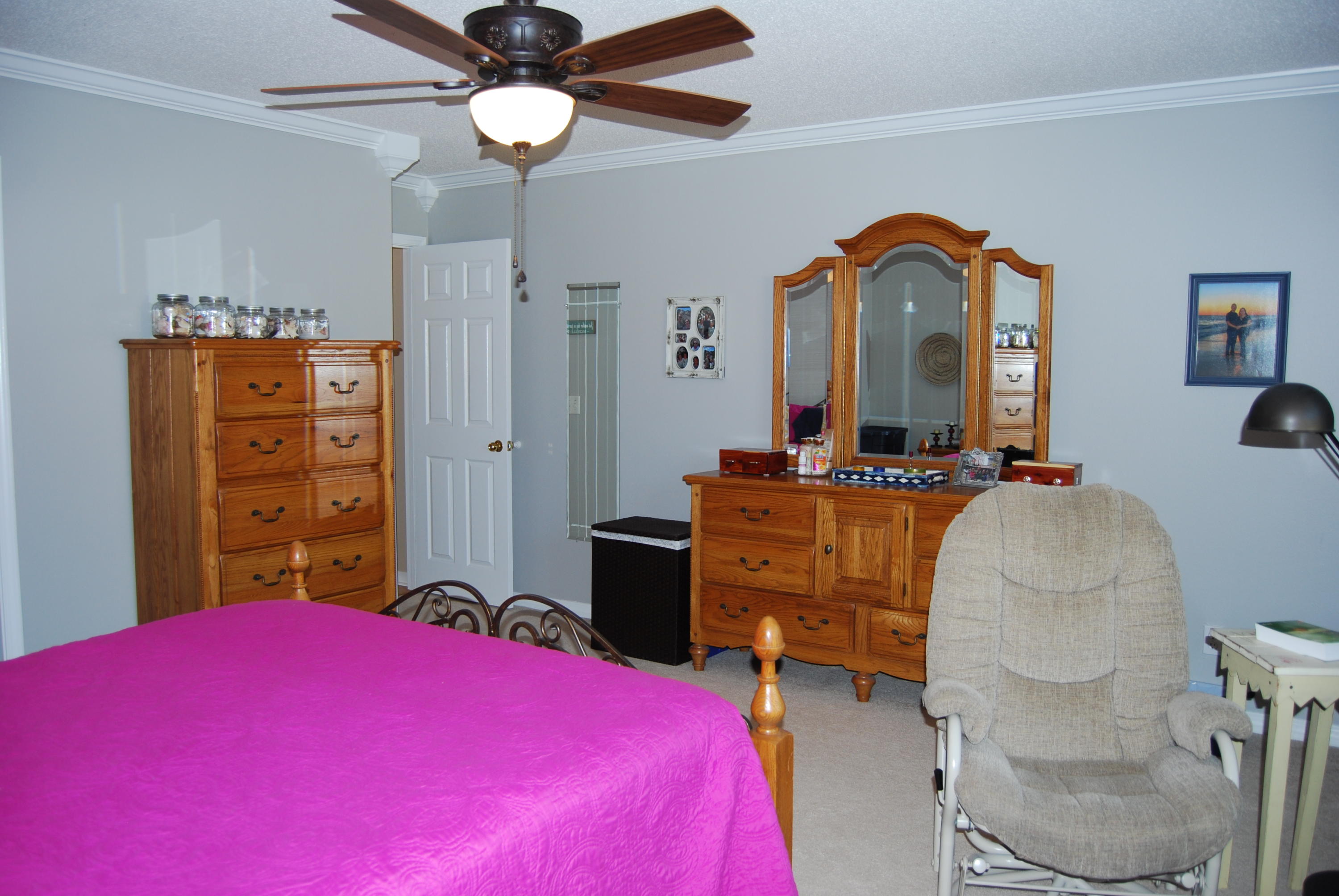 4455 Kingslynn Road Niceville, FL 32578 - Photo 17 of 36 a bedroom with a bed and a chandelier