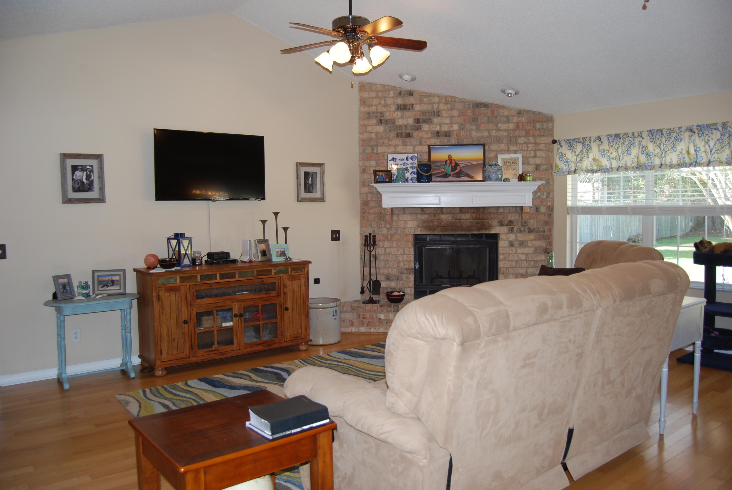 4455 Kingslynn Road Niceville, FL 32578 - Photo 3 of 36 a living room with furniture a flat screen tv and a fireplace