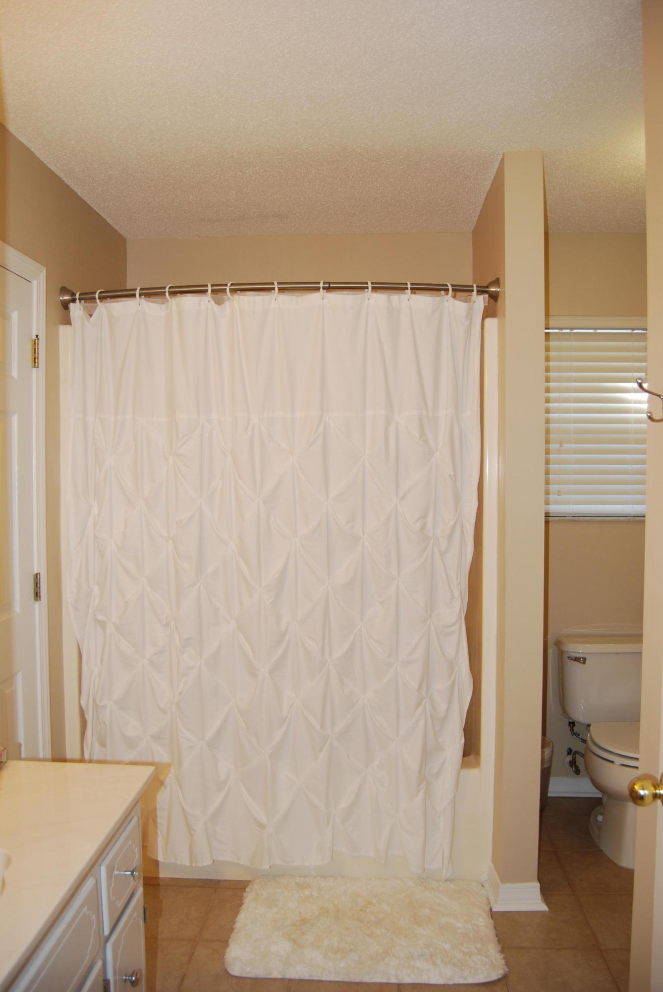 4455 Kingslynn Road Niceville, FL 32578 - Photo 24 of 36 a bathroom with a shower curtain and a sink