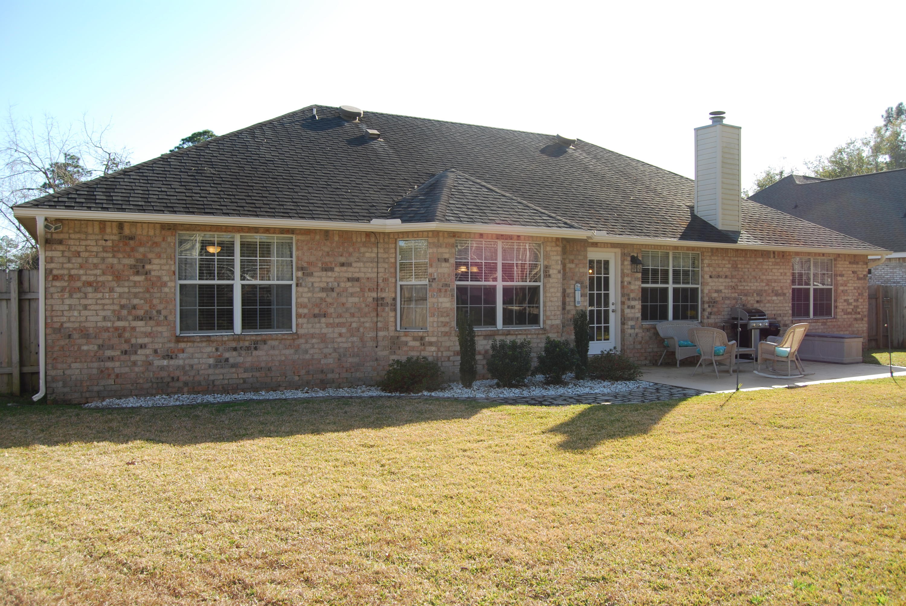 4455 Kingslynn Road Niceville, FL 32578 - Photo 34 of 36 a house view with swimming pool in front of it