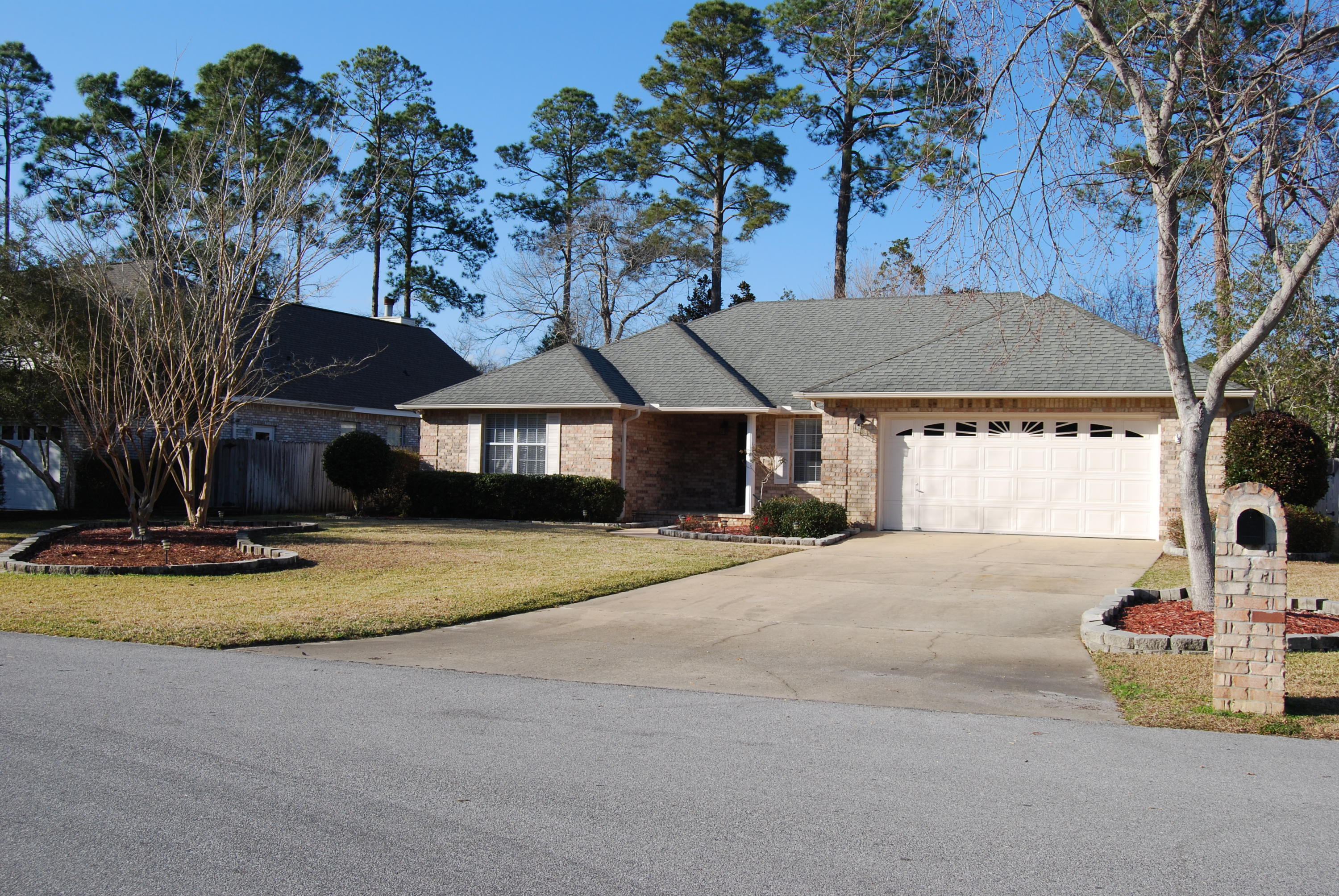 4455 Kingslynn Road Niceville, FL 32578 - Photo 35 of 36 a house with trees in the background