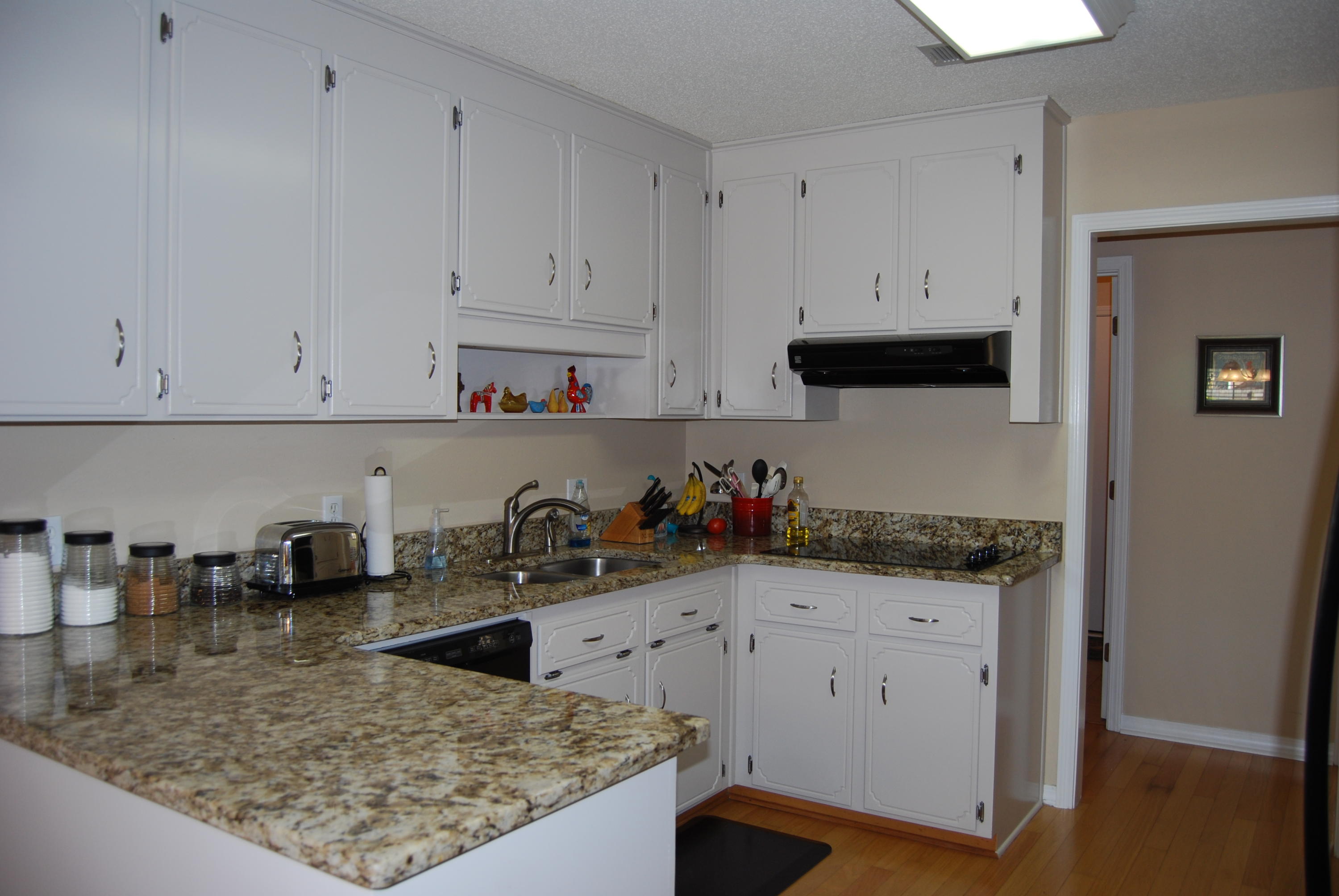 4455 Kingslynn Road Niceville, FL 32578 - Photo 10 of 36 a kitchen with white cabinets and a sink