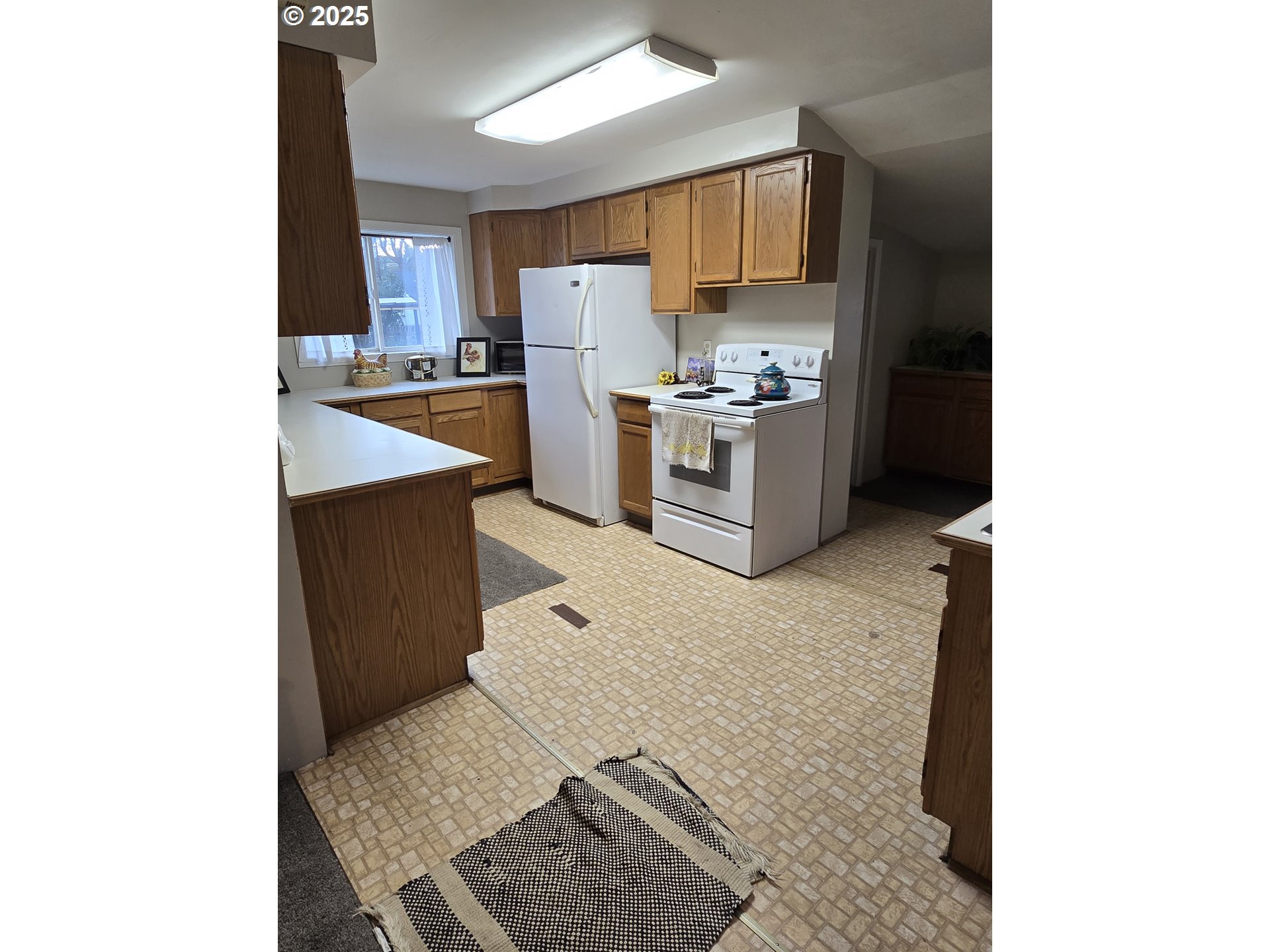 515 West Main Street Enterprise, OR 97828 - Photo 16 of 22 a kitchen with stainless steel appliances kitchen island granite countertop a refrigerator sink and cabinets