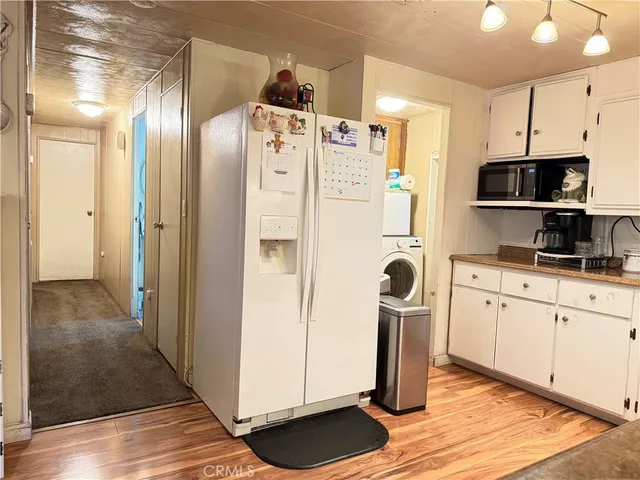 a kitchen with stainless steel appliances granite countertop a refrigerator and a stove