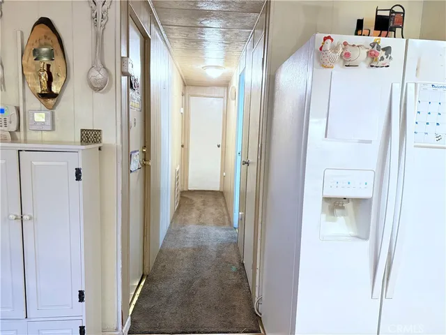 a view of a hallway to rooms